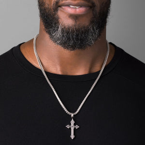 man wears a silver cross necklace men's chain