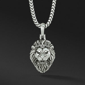 a fierce growling silver lion head pendant hangs from a silver necklace