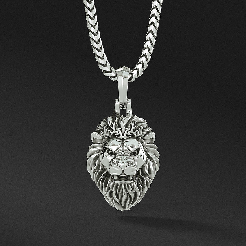 a fierce growling silver lion head pendant hangs from a silver necklace