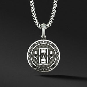 a polished silver medallion for men with the hourglass and two sculpted tulips