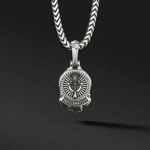 the back of a mens silver pendant features an ankh and detailed designs