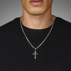 a man in a black shirt wears a sterling silver cross pendant