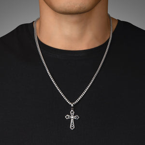 a man in a black shirt wears a sterling silver cross pendant