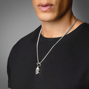 a man in a black shirt wearing a silver Spartan pendant hanging from a 3mm franco chain