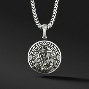 a round and polished silver Saint Christopher pendant with the sculpted saint carrying baby Jesus