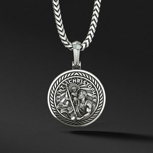 a round and polished silver Saint Christopher pendant with the sculpted saint carrying baby Jesus