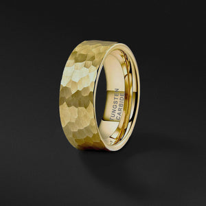 a mens gold tungsten wedding band with a satin hammered texture shines