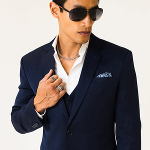 a well dressed man in a blue suit and sunglasses wearing a 5mm white gold franco chain