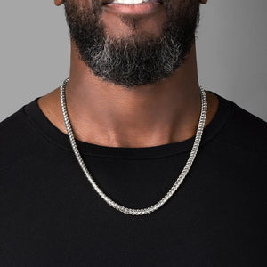 a man in a black shirt wearing a 5mm diamond cut franco white gold necklace for men