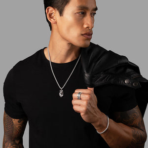 sleek man with a black shirt and leather jacket wearing silver mens jewelry